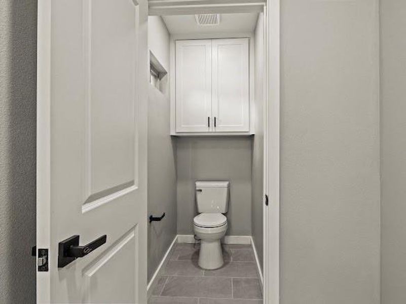 Bathroom featuring toilet and light tile patterned floors