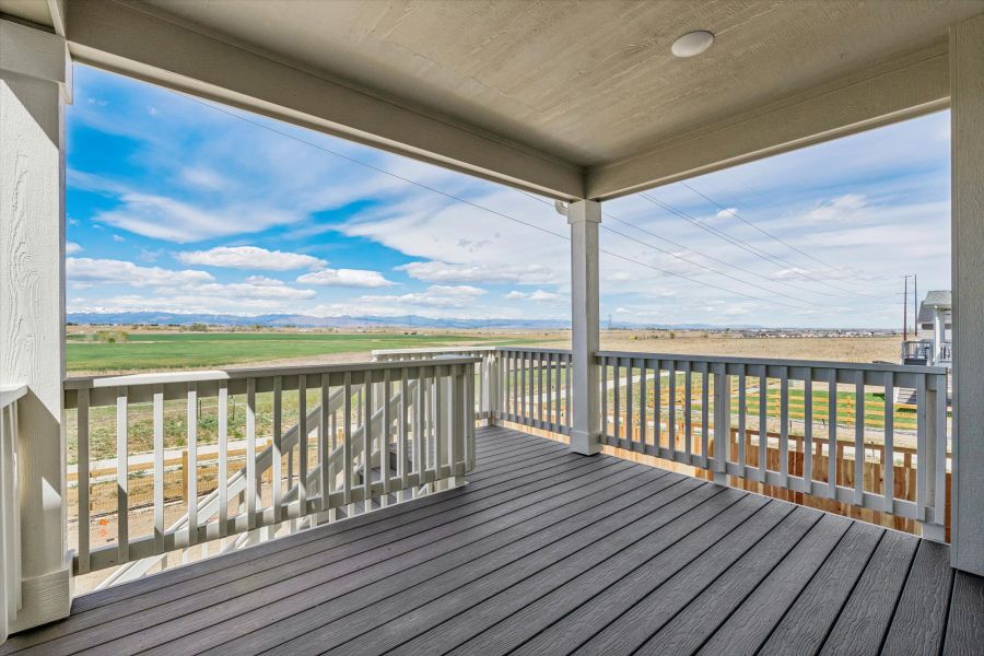 A deck with a view of the ocean and land. A deck with a view of the ocean and land.