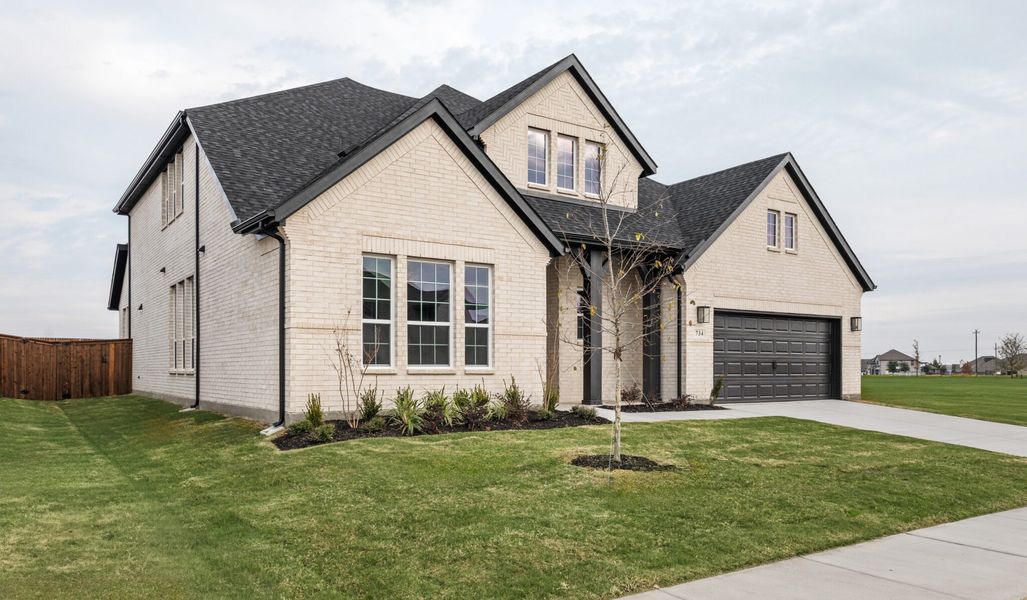 Front exterior of a new home in Lake Breeze, Lavon, TX, highlighting curb appeal (Image 2). Front exterior of a new home in Lake Breeze, Lavon, TX, highlighting curb appeal (Image 2).