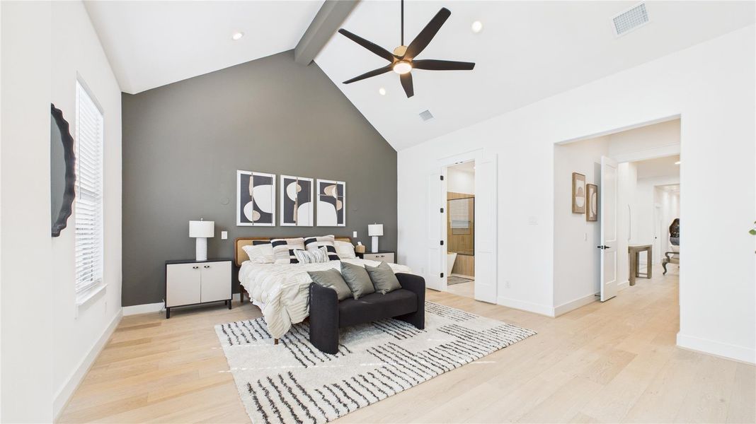 Primary Bedroom with vaulted ceiling and big windows filled with abundant natural light, fits king size bed and night stands, as well as a full sofa and chairs set **Photo of the model home with upgrade: accent wall**