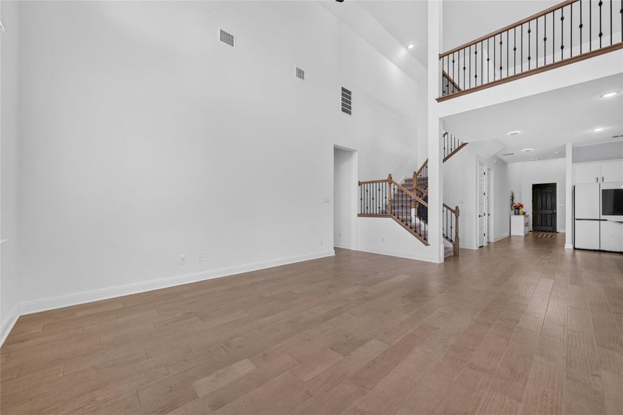 Gleaming hardwood floors and towering ceilings define this airy, open-concept living space. Gleaming hardwood floors and towering ceilings define this airy, open-concept living space.