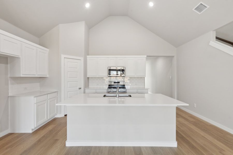 Kitchen in the Claret home plan by Trophy Signature Homes – REPRESENTATIVE PHOTO