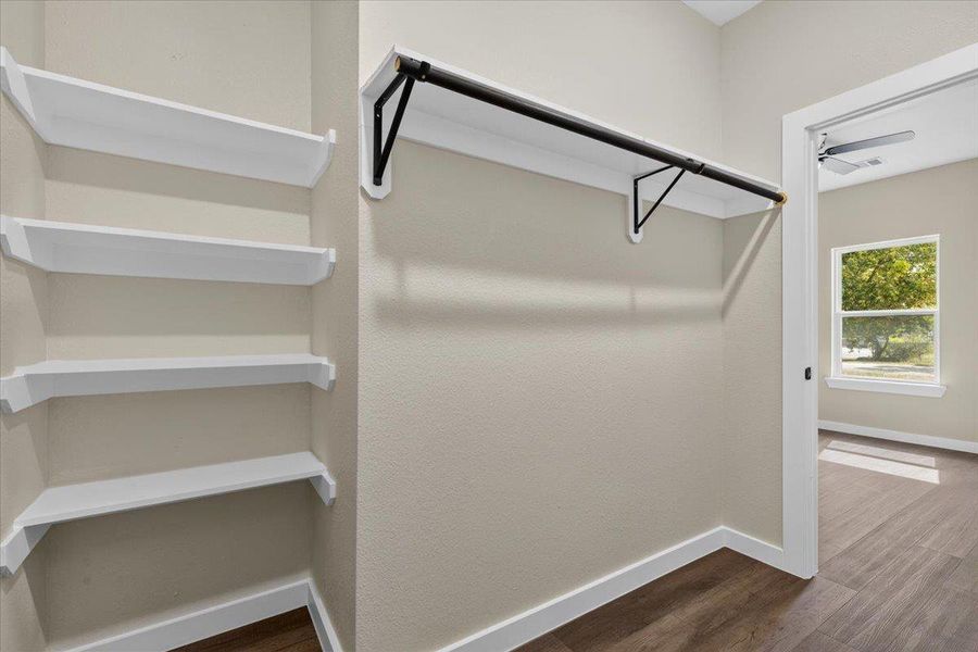 Ample built-in shelving and hanging rods maximize storage efficiency on durable wood-look flooring. Ample built-in shelving and hanging rods maximize storage efficiency on durable wood-look flooring.