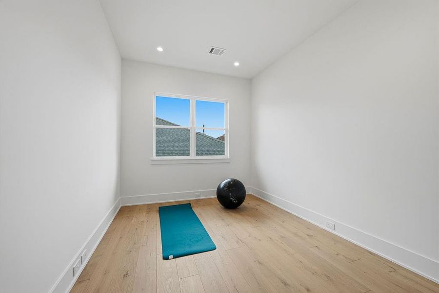Upper-level flex room provides the ultimate footprint for customization. Defined by an airy, open feel and high-end architectural finishes, the space is designed to evolve with your needs, serving as anything from a private yoga studio to a sophisticated hobby room.