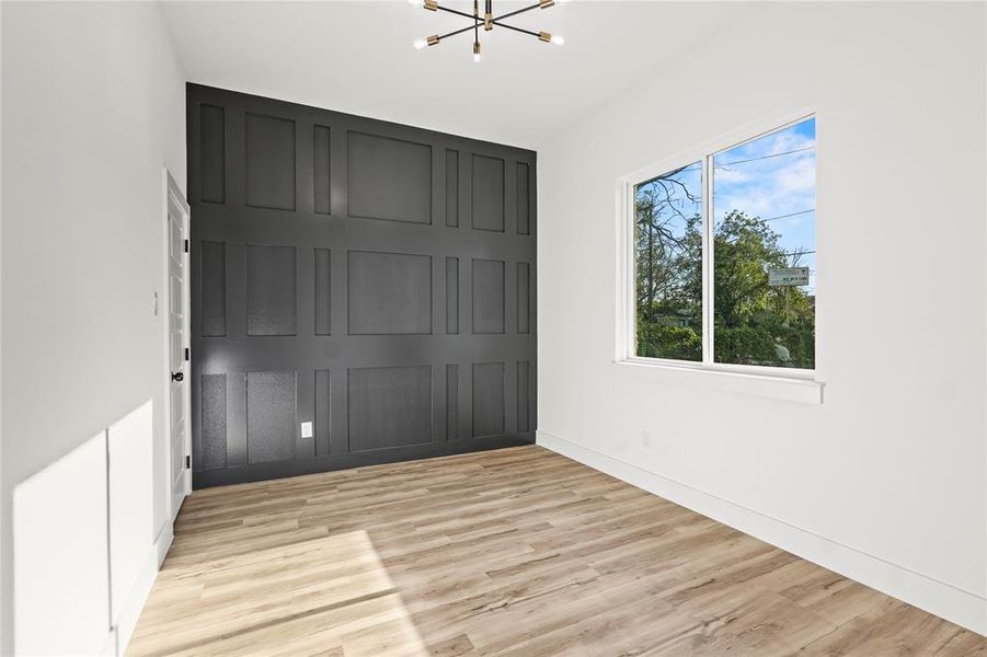 Unfurnished bedroom with a chandelier, light wood-style flooring, and a closet