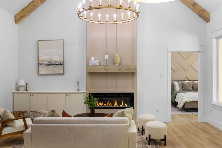 Living room with light hardwood / wood-style flooring, beam ceiling, and plenty of natural light