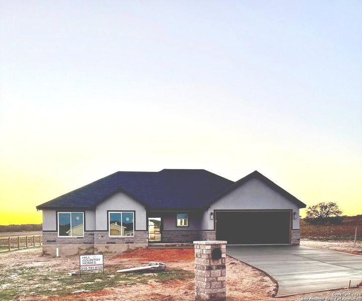 Front exterior of a new home in , La Vernia, TX, highlighting curb appeal (Image 12).