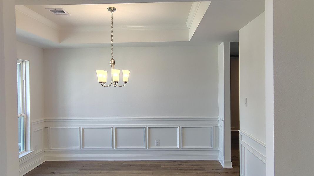 Formal dining with wainscoting, trey ceiling and crown molding