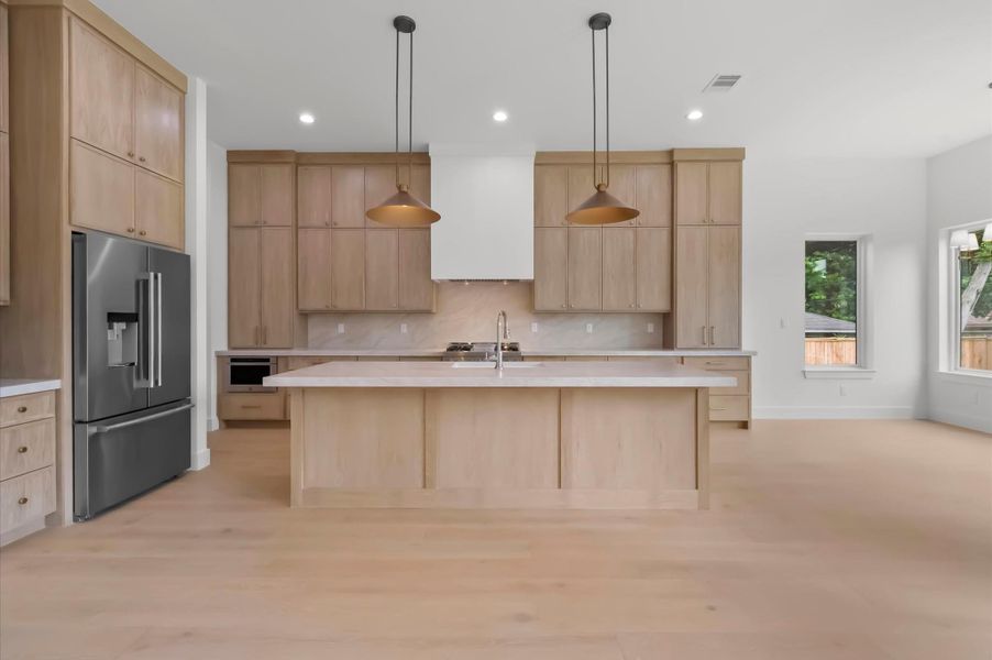 Oversized island, designer lighting and abundant natural light. Oversized island, designer lighting and abundant natural light.