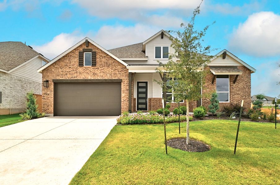 Front exterior of a new home in 6 Creeks at Waterridge, Kyle, TX, highlighting curb appeal (Image 1). Front exterior of a new home in 6 Creeks at Waterridge, Kyle, TX, highlighting curb appeal (Image 1).
