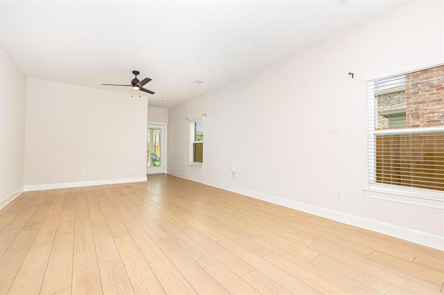 Empty room featuring light wood-style floors and ceiling fan Empty room featuring light wood-style floors and ceiling fan