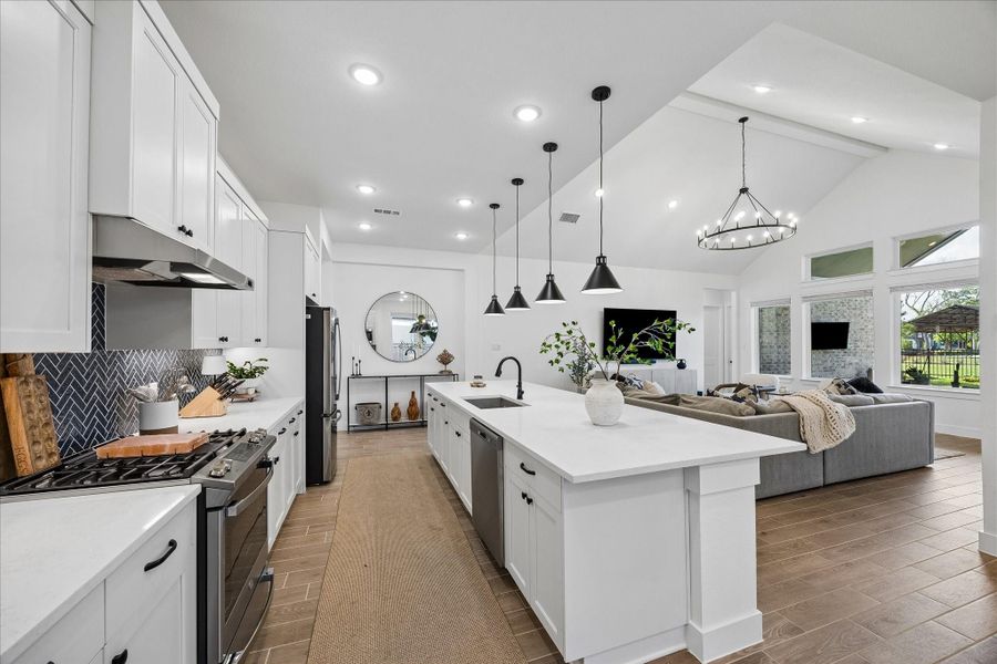 Well equipped kitchen features stainless steel appliances including a gas range, built in microwave, dishwasher, and refrigerator, all paired with sleek quartz countertops. Functional layout is centered around a large island with sink, offering plenty of prep space while keeping everything within easy reach. Well equipped kitchen features stainless steel appliances including a gas range, built in microwave, dishwasher, and refrigerator, all paired with sleek quartz countertops. Functional layout is centered around a large island with sink, offering plenty of prep space while keeping everything within easy reach.