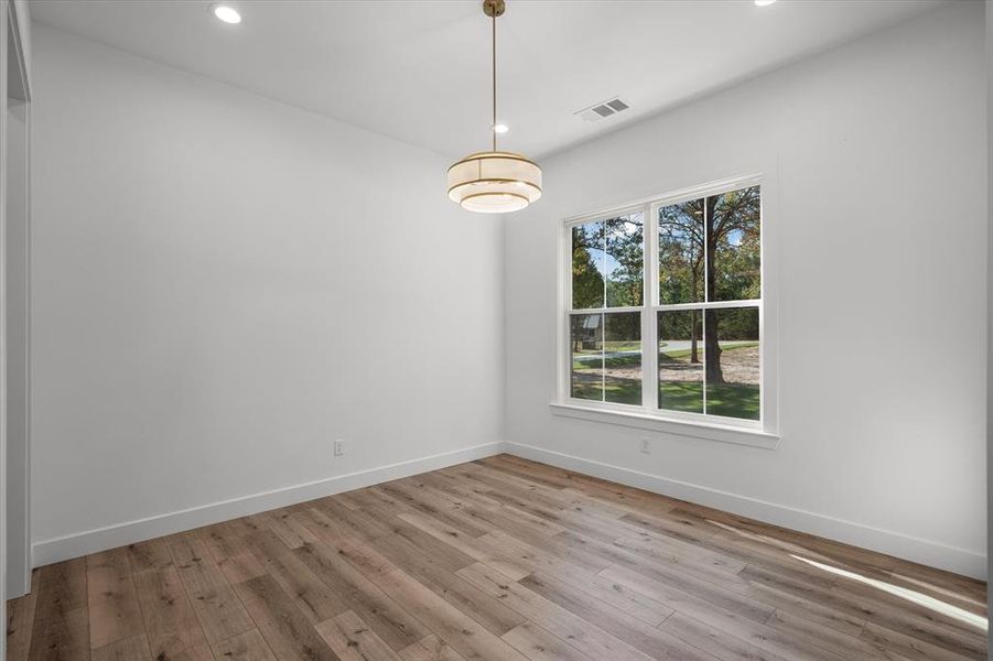 Unfurnished dining area with recessed lighting and light wood finished floors