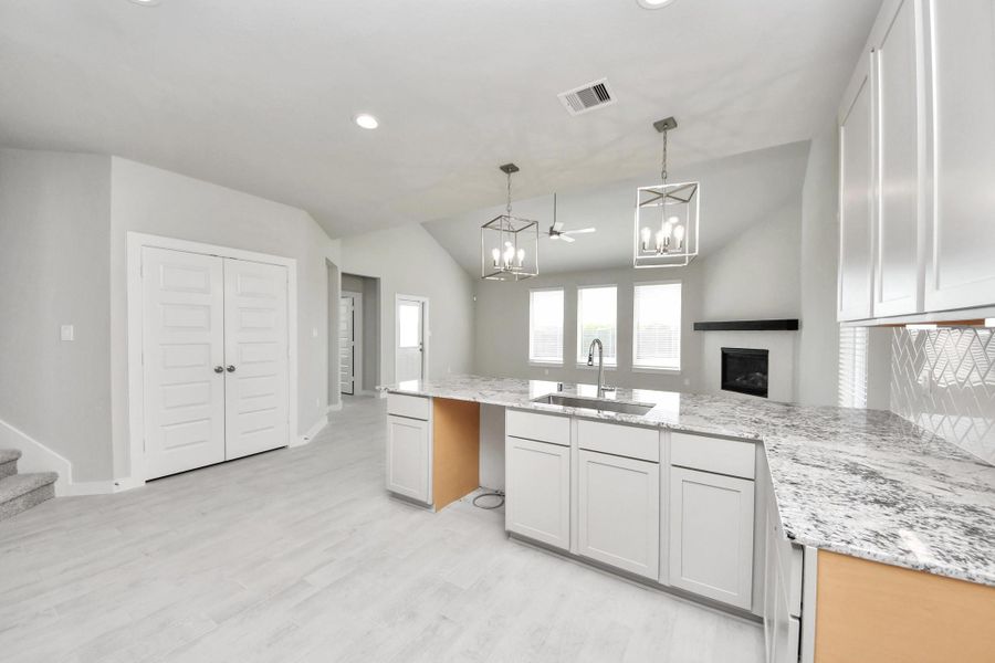 All of this overlooks your expansive family room, creating a perfect space for culinary delights and family gatherings. Sample photo of completed home with similar floor plan. Actual colors and selections may vary.