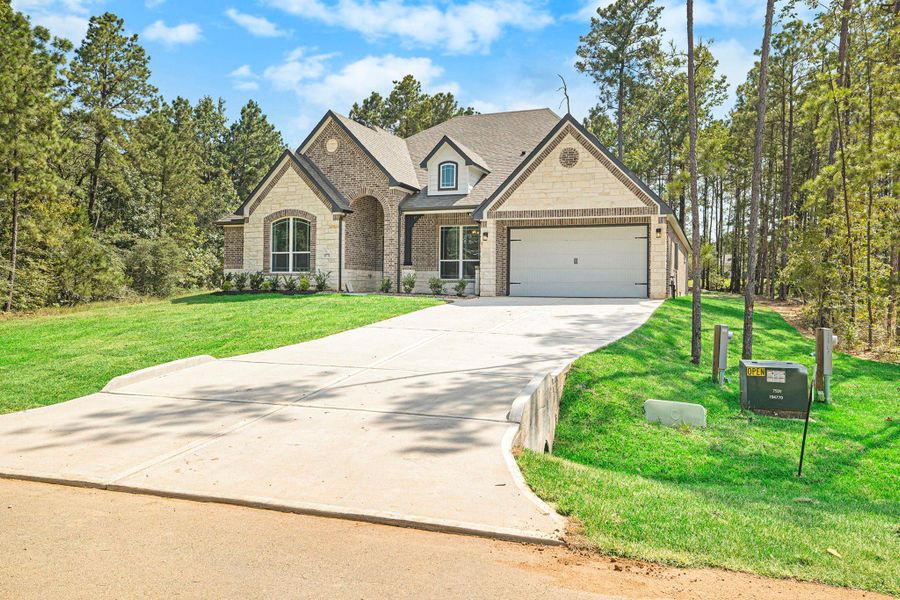 Front exterior of a new home in Oakwood Ranch, Willis, TX, highlighting curb appeal (Image 17). Front exterior of a new home in Oakwood Ranch, Willis, TX, highlighting curb appeal (Image 17).