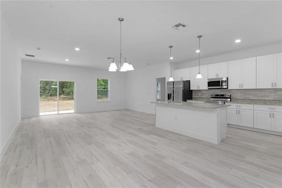 From the entry looking through dining area to living area at the back of the house