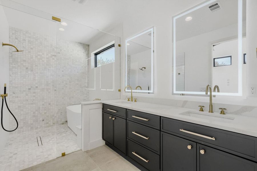 Bathroom with double vanity, a walk in shower, a freestanding tub, light tile patterned floors, and recessed lighting Bathroom with double vanity, a walk in shower, a freestanding tub, light tile patterned floors, and recessed lighting