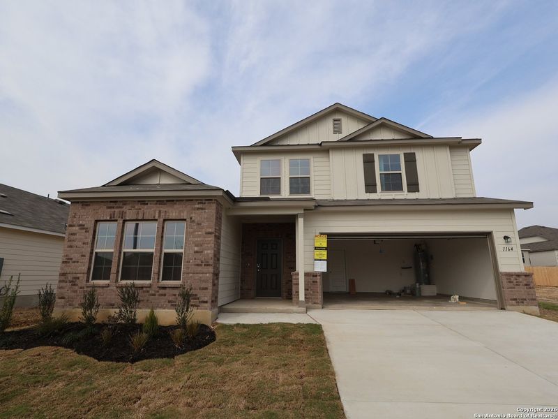 Front exterior of a new home in Greenspoint Heights, Seguin, TX, highlighting curb appeal (Image 20).