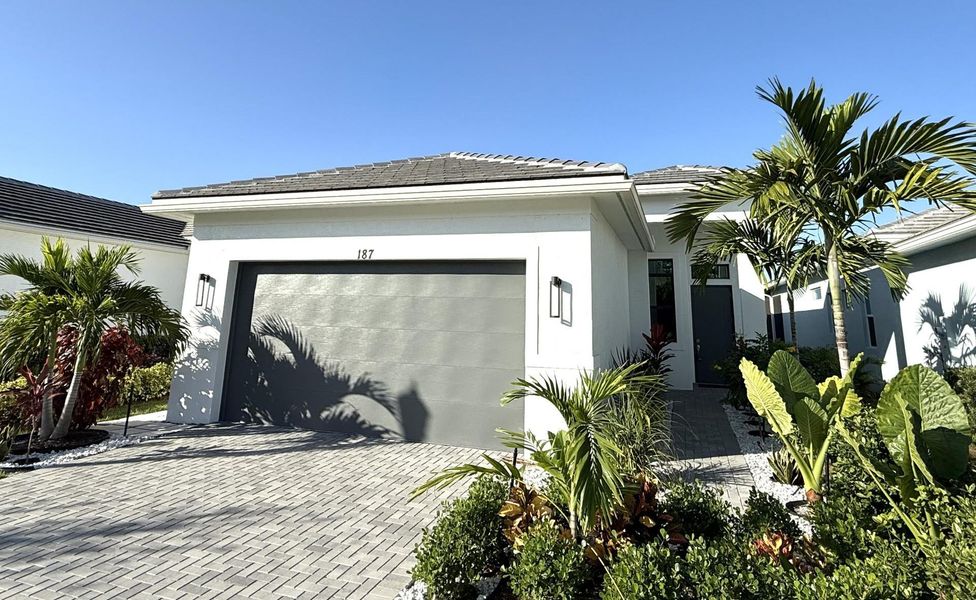 Front exterior of a new home in , Port St. Lucie, FL, highlighting curb appeal (Image 1).