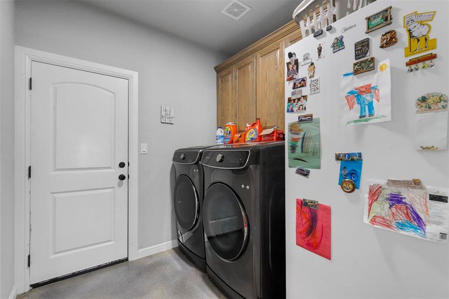 Laundry area featuring cabinets and independent washer and dryer