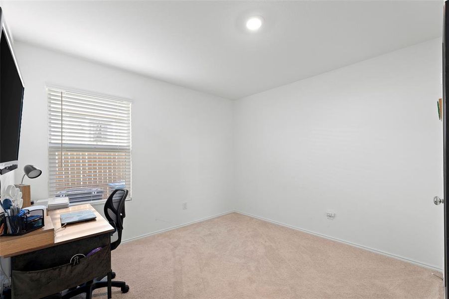 Office space featuring light colored carpet and baseboards