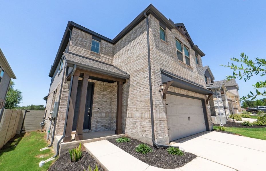 Front exterior of a new home in Wolf Ranch, Georgetown, TX, highlighting curb appeal (Image 23).