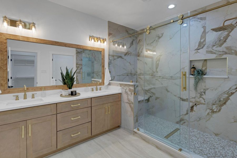 Elegant primary bath featuring a spacious shower, dual sinks, and premium finishes. Elegant primary bath featuring a spacious shower, dual sinks, and premium finishes.
