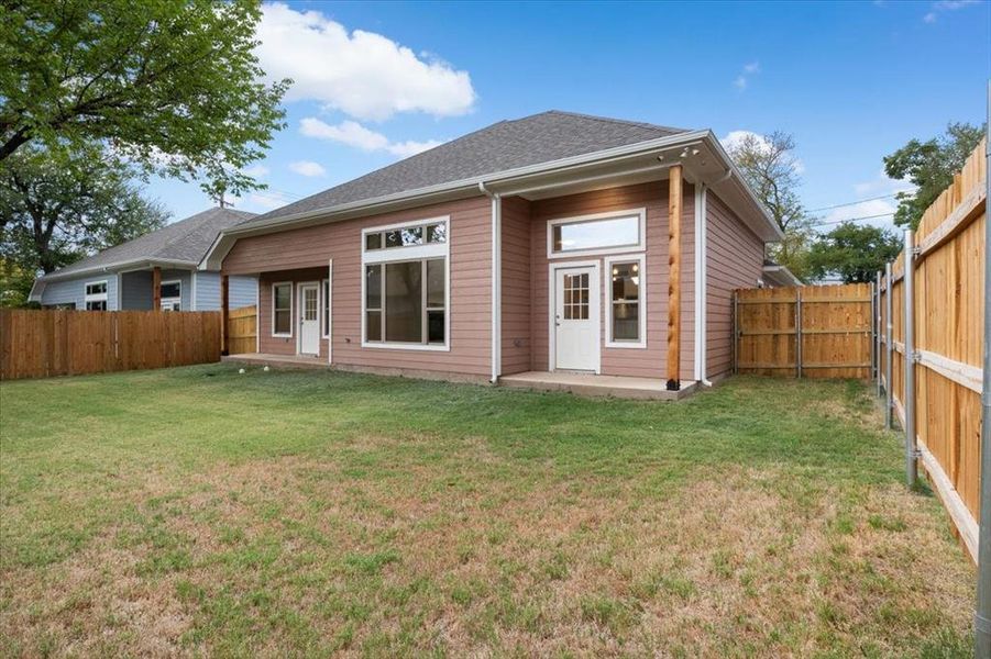 Rear view of property featuring a yard