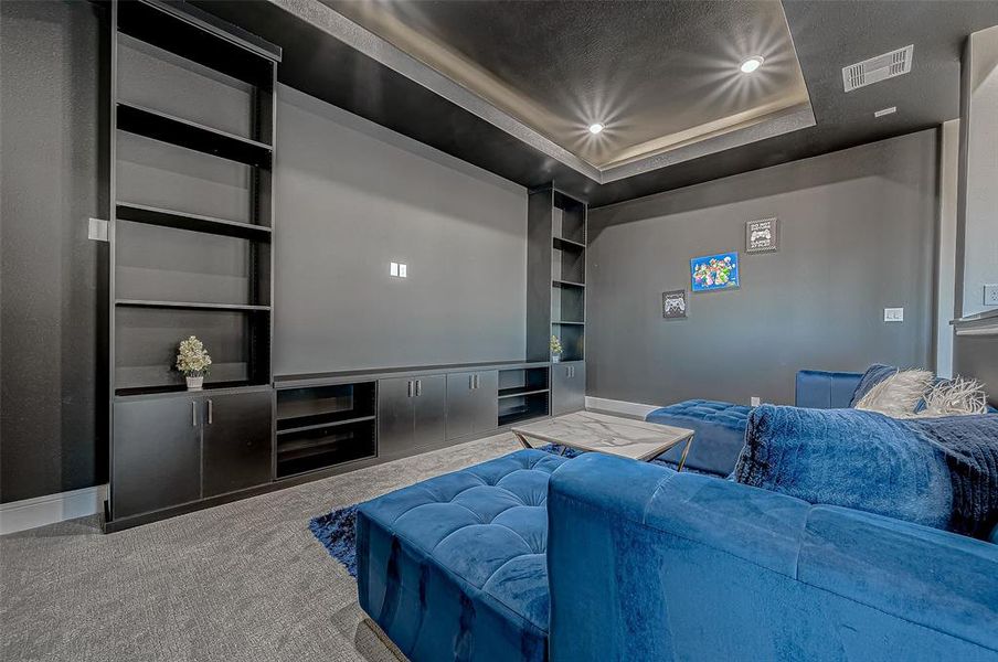 Indulge in the luxury of your own private movie theater, designed for an unparalleled cinematic experience. Pre-wired for premium sound and featuring custom-built shelving, this space epitomizes the sophistication and elegance of the home.