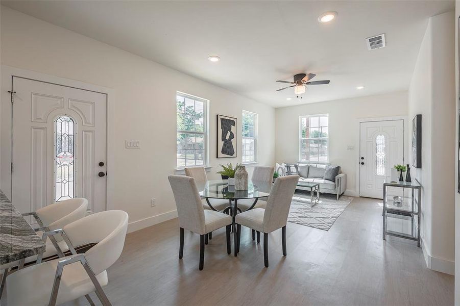 Dining area featuring a healthy amount of sunlight, ceiling fan, and light hardwood / wood-style floors