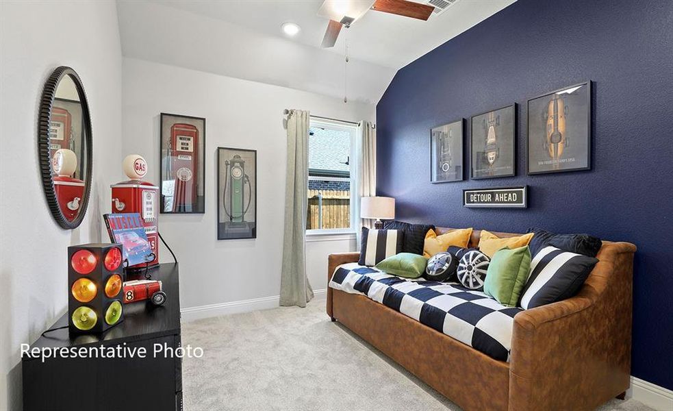 Carpeted living room featuring vaulted ceiling and a ceiling fan