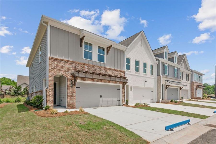 Front exterior of a new home in Wilkins Walk, Mableton, GA, highlighting curb appeal (Image 24). Front exterior of a new home in Wilkins Walk, Mableton, GA, highlighting curb appeal (Image 24).