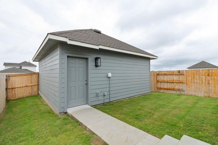 View of outdoor structure featuring a fenced backyard