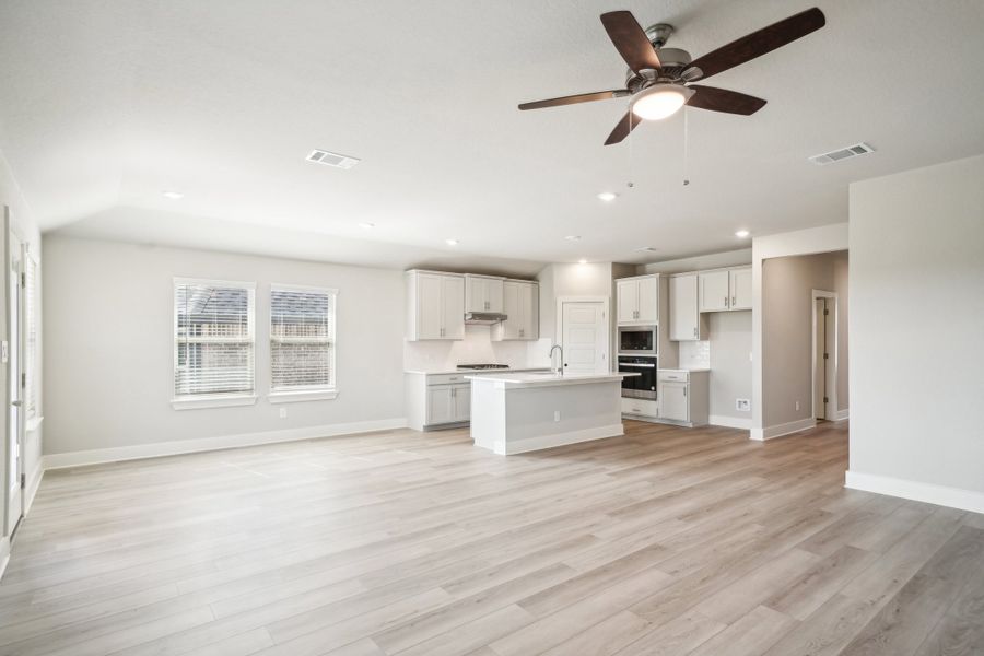 Dining room and kitchen in the Preston floorplan at a Meritage Homes community.