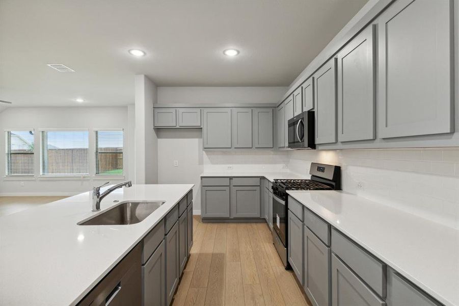 Kitchen in the Oscar home plan by Trophy Signature Homes – REPRESENTATIVE PHOTO Kitchen in the Oscar home plan by Trophy Signature Homes – REPRESENTATIVE PHOTO