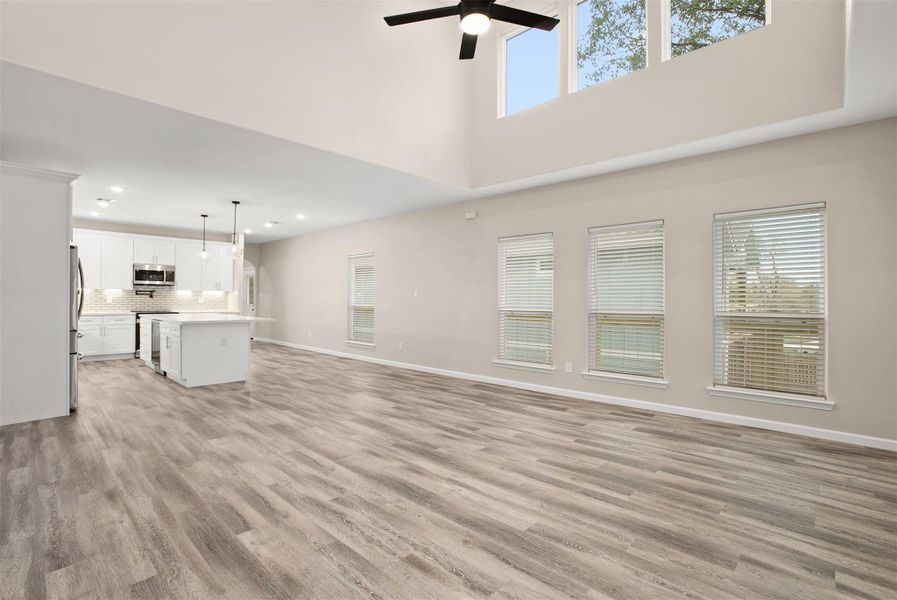 Large living area with 20 ft ceiling and skylight