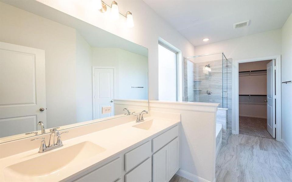 Bathroom featuring independent shower and bath and vanity