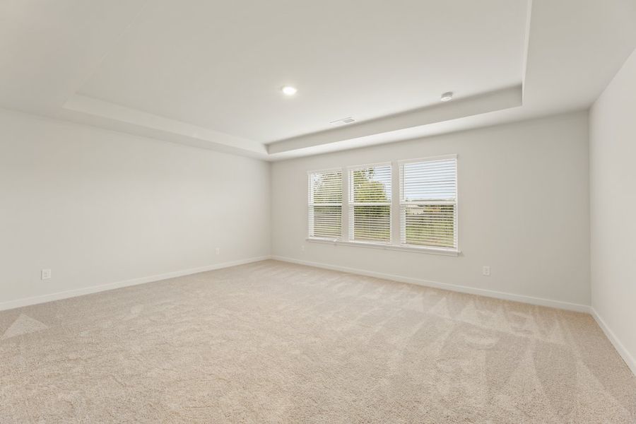 A room with a window and a carpet. A room with a window and a carpet.