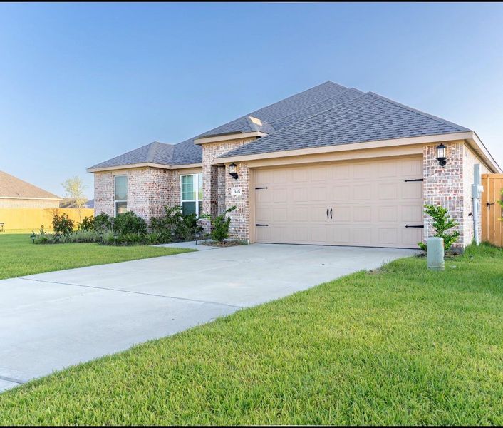Front exterior of a new home in Lago Mar, Texas City, TX, highlighting curb appeal (Image 2). Front exterior of a new home in Lago Mar, Texas City, TX, highlighting curb appeal (Image 2).