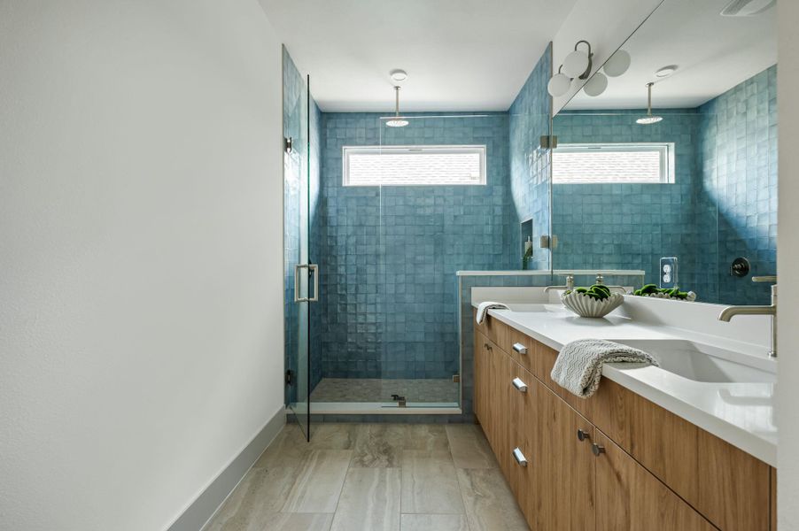 A rain shower head and spacious dual vanity create a calming bathroom retreat. A rain shower head and spacious dual vanity create a calming bathroom retreat.
