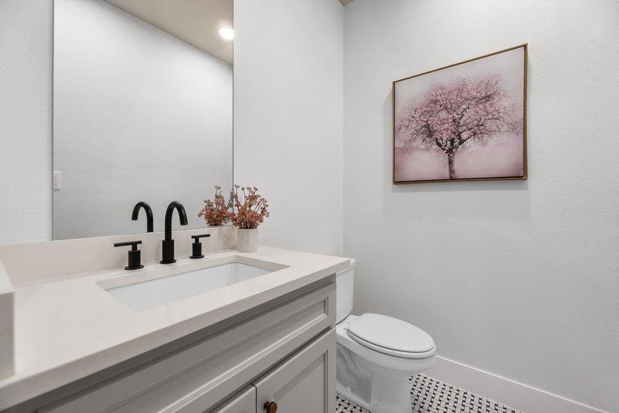 Half bath featuring vanity and tile patterned flooring Half bath featuring vanity and tile patterned flooring