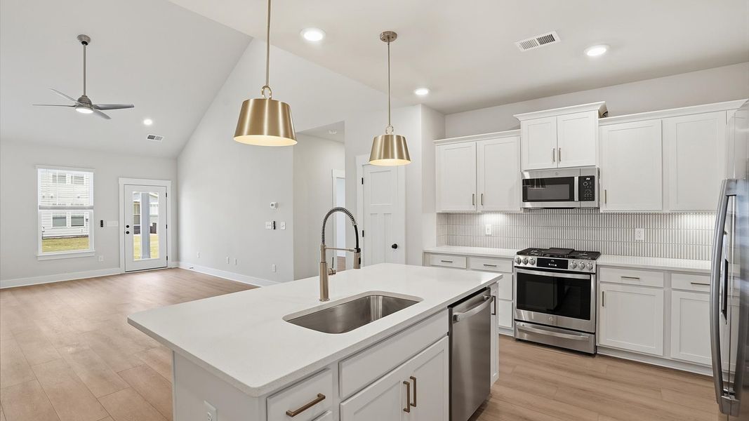 Tasteful kitchen with a center island and stylish pendant lighting—crafted to high standards near Downtown Anderson Tasteful kitchen with a center island and stylish pendant lighting—crafted to high standards near Downtown Anderson