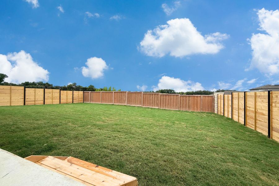 A spacious, grassy backyard provides an ideal setting for outdoor activities and private enjoyment. A spacious, grassy backyard provides an ideal setting for outdoor activities and private enjoyment.
