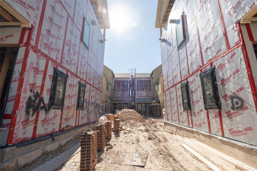 Progress as of 2/1/26. View of the community from the shared driveway.