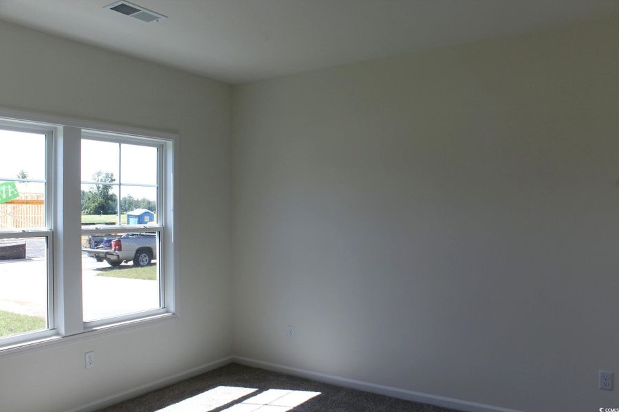 Carpeted spare room featuring baseboards Carpeted spare room featuring baseboards