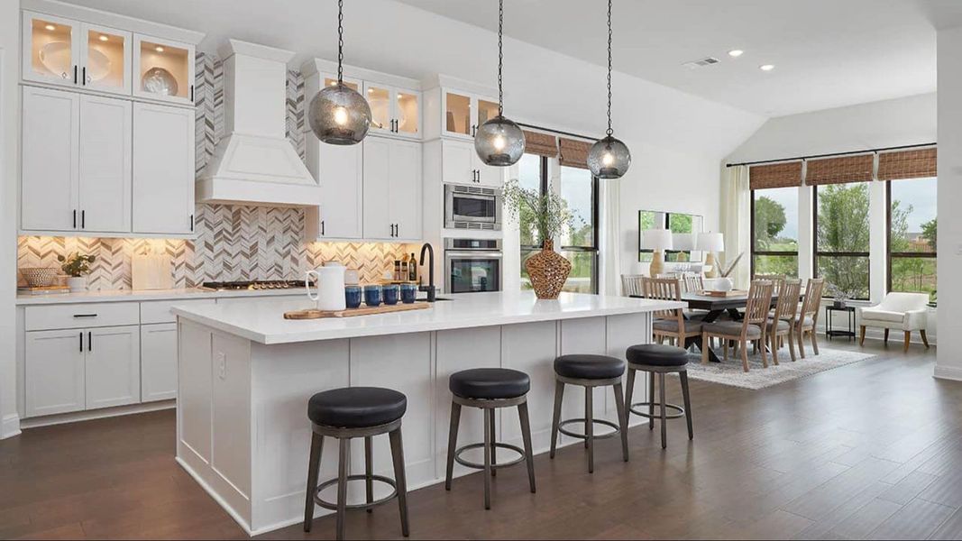 Kitchen featuring white cabinetry, glass insert cabinets, pendant lighting, a breakfast bar area, and dark wood-style floors Kitchen featuring white cabinetry, glass insert cabinets, pendant lighting, a breakfast bar area, and dark wood-style floors