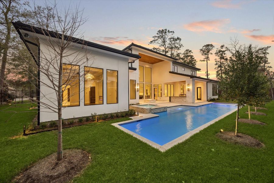 Resort-inspired backyard featuring a sleek pool and spa, expansive covered outdoor living pavillion, outdoor kitchen, and seamless indoor-outdoor living designed for year-round entertaining. Resort-inspired backyard featuring a sleek pool and spa, expansive covered outdoor living pavillion, outdoor kitchen, and seamless indoor-outdoor living designed for year-round entertaining.