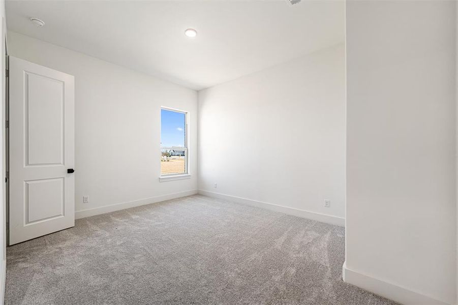 Unfurnished room featuring light colored carpet and baseboards