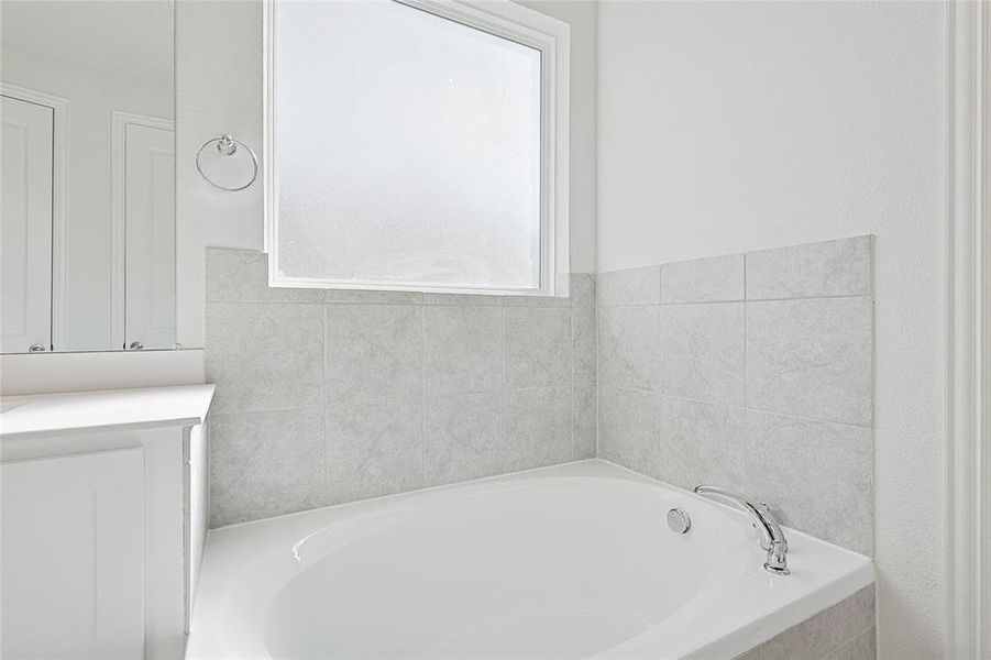 Bathroom featuring tiled tub