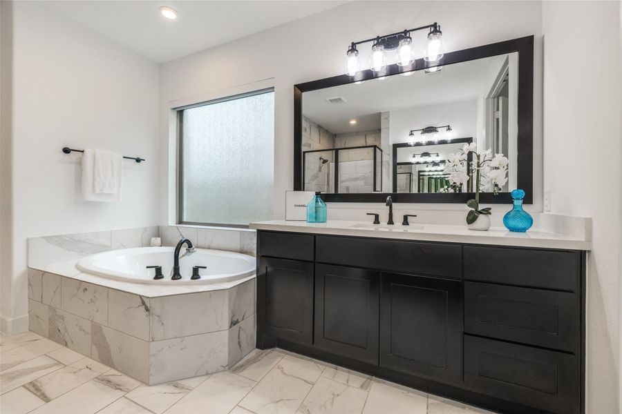 Beautiful Primary Suite with stand alone shower, large bath, beautiful dark cabinets, dual sinks  oil rubber bronze fittings